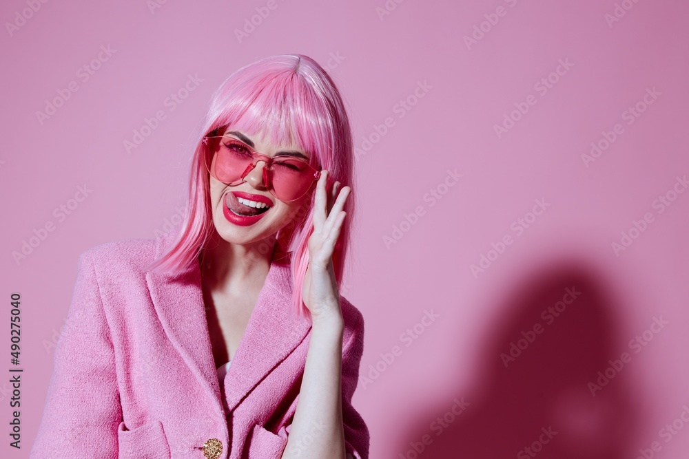 Portrait of a young woman gesturing with hands pink jacket lifestyle glamor pink background unaltered Portrait of a young woman gesturing with hands pink jacket lifestyle glamor pink background unaltered