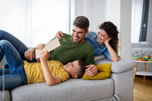 Happy family spending time together, playing at home. © NDABCREATIVITY