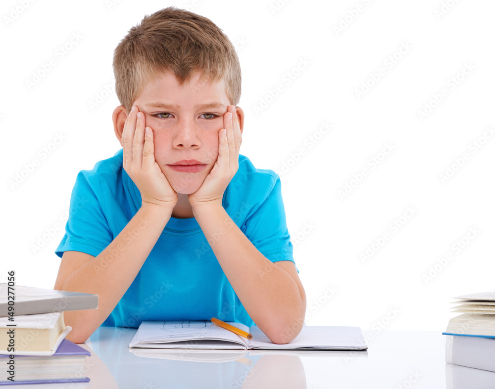 I like studying hard. Shot of bored boy sitting with his homework against a white background. I like studying hard. Shot of bored boy sitting with his homework against a white background.