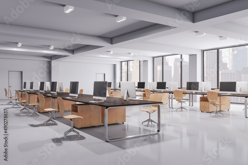 Clean concrete and wooden coworking office interior with equipment, furniture and computer monitors. Design and workplace concept. 3D Rendering. © Who is Danny