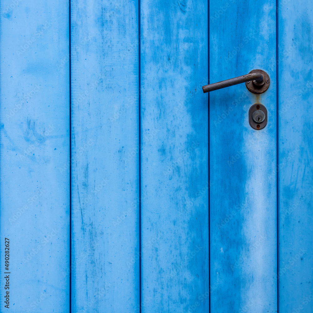 Blue painted door closeup with simple handle, plenty of space for text or logo Blue painted door closeup with simple handle, plenty of space for text or logo
