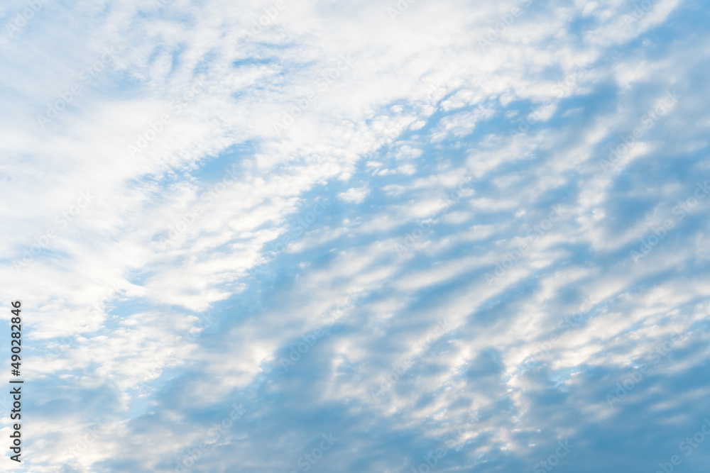 Smooth white clouds on clear blue sky background and copy space. Outdoor nature or save the earth concept.