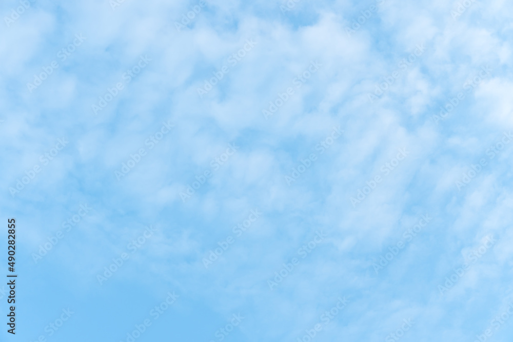 Smooth white clouds on clear blue sky background and copy space. Outdoor nature or save the earth concept.