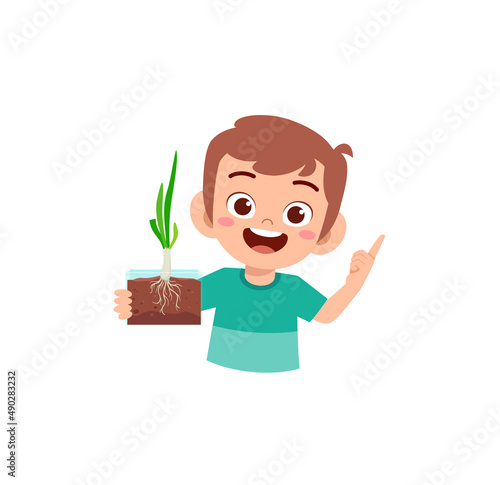 little boy observe plant growing in garden