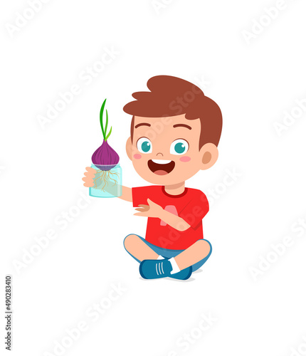 little boy observe plant growing in garden