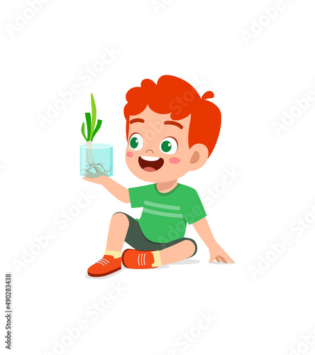 little boy observe plant growing in garden