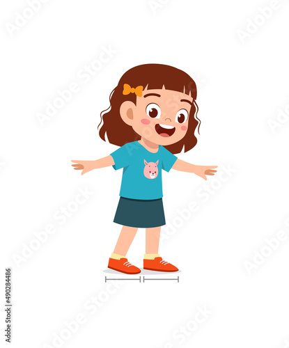 cute little girl measure length using foot step photo