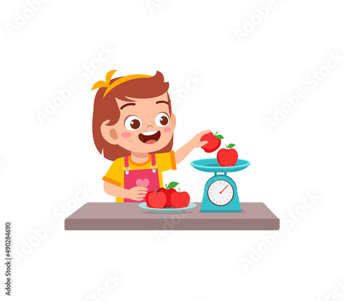 little girl measure weight of fruit using weighing scale