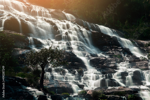 Fotobehang waterfall in the mountains with evening light.