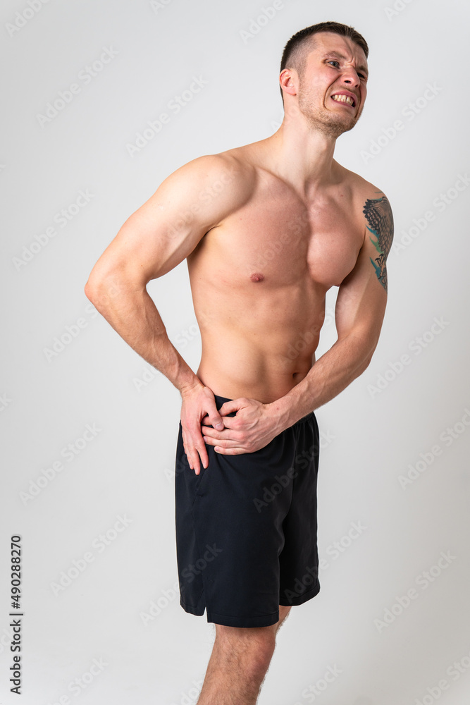 Fototapeta premium Aching hip in a man white background strong ache spine background stress, holding. Tension red sickness, lower suffer attractive