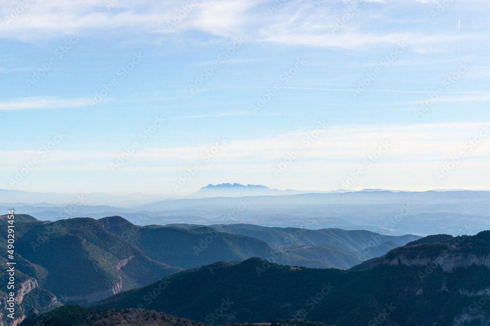 Mountains landscape with the Montserrat massif on the horizon above the clouds