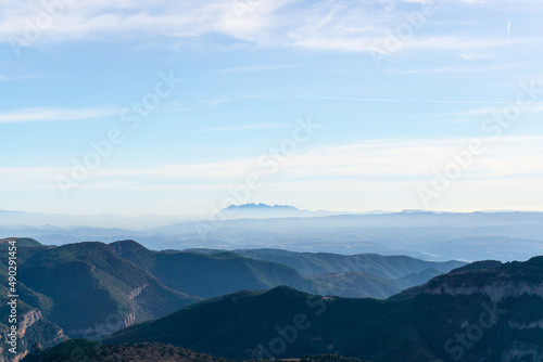 Mountains landscape with the Montserrat massif on the horizon above the clouds