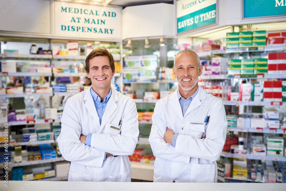 Our quality service comes at no cost. Portrait of two male pharmacists working in a chemist.