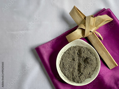 Fotografie Lent Season,Holy Week and Good Friday Concepts - image of bowl of ash with cross made of palm leave background