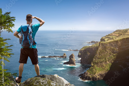 Hiker with a view over a scenic coastline