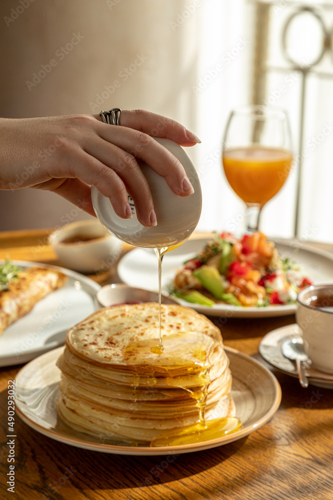 traditional Russian pastries: pancakes for Maslenitsa, pancakes with salmon, pancakes with honey, pancakes for breakfast