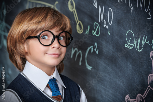 Vászonkép schoolboy by blackboard