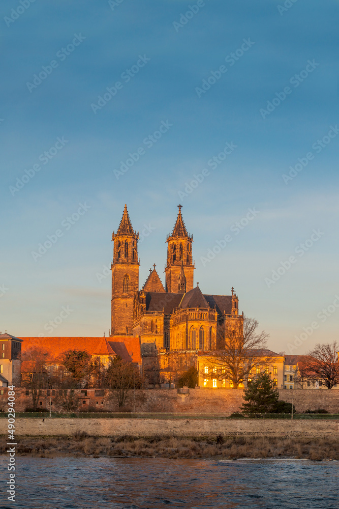View over historical downtown of Magdeburg, old town, Elbe river and Magnificent Cathedral at early morning hours with warm illumination, Magdeburg, Germany.
