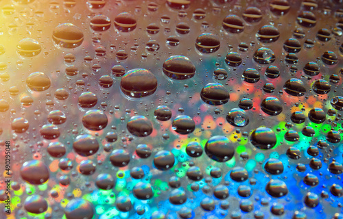 colorful waterdrops on steamy window.