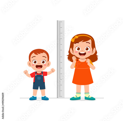 boy and girl measure height and compare grow progress