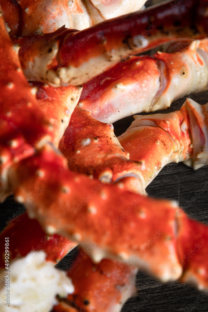 crab phalanx, sea delicacy on a dark background. large red Kamchatka crab claws phalanx legs tentacles crab phalanx, sea delicacy on a dark background. large red Kamchatka crab claws phalanx legs tentacles