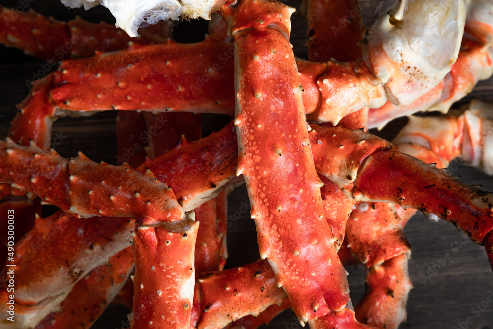 crab phalanx, sea delicacy on a dark background. large red Kamchatka crab claws phalanx legs tentacles crab phalanx, sea delicacy on a dark background. large red Kamchatka crab claws phalanx legs tentacles