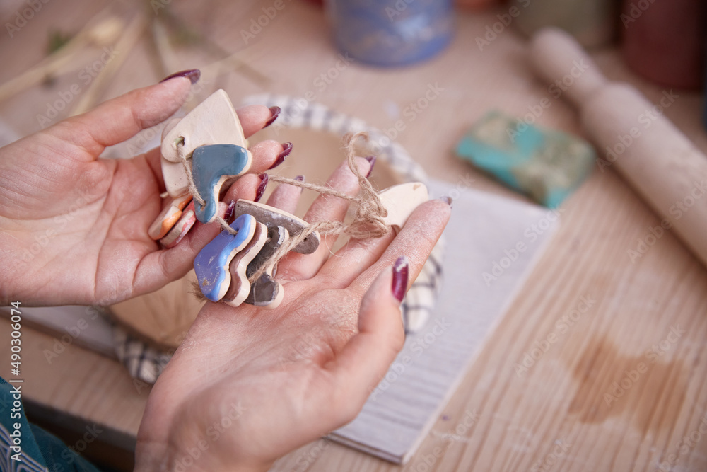 female hands of the ceramist choose the color of the product.