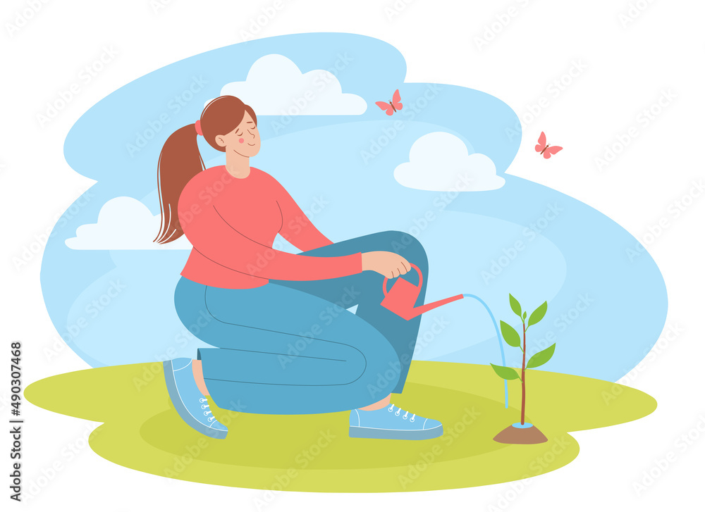 Young woman is watering a small tree from a watering can. Garden, vegetable garden, spring planting, flowers care.