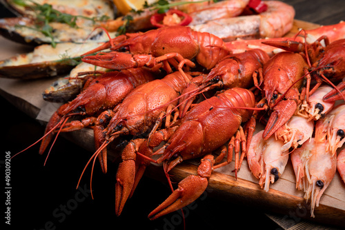 a plate of various snacks, seafood, mussels, boiled crayfish, shrimps