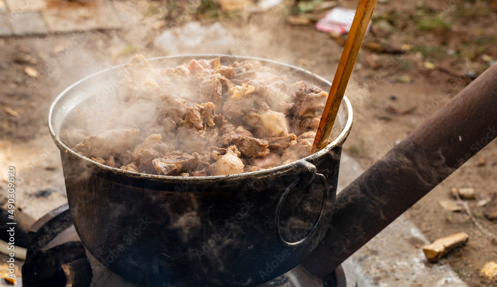 Kavurma is a Turkic sheep meat dish. Pieces of meat are stewed in a large cauldron over an open fire. Kavurma is a Turkic sheep meat dish. Pieces of meat are stewed in a large cauldron over an open fire.
