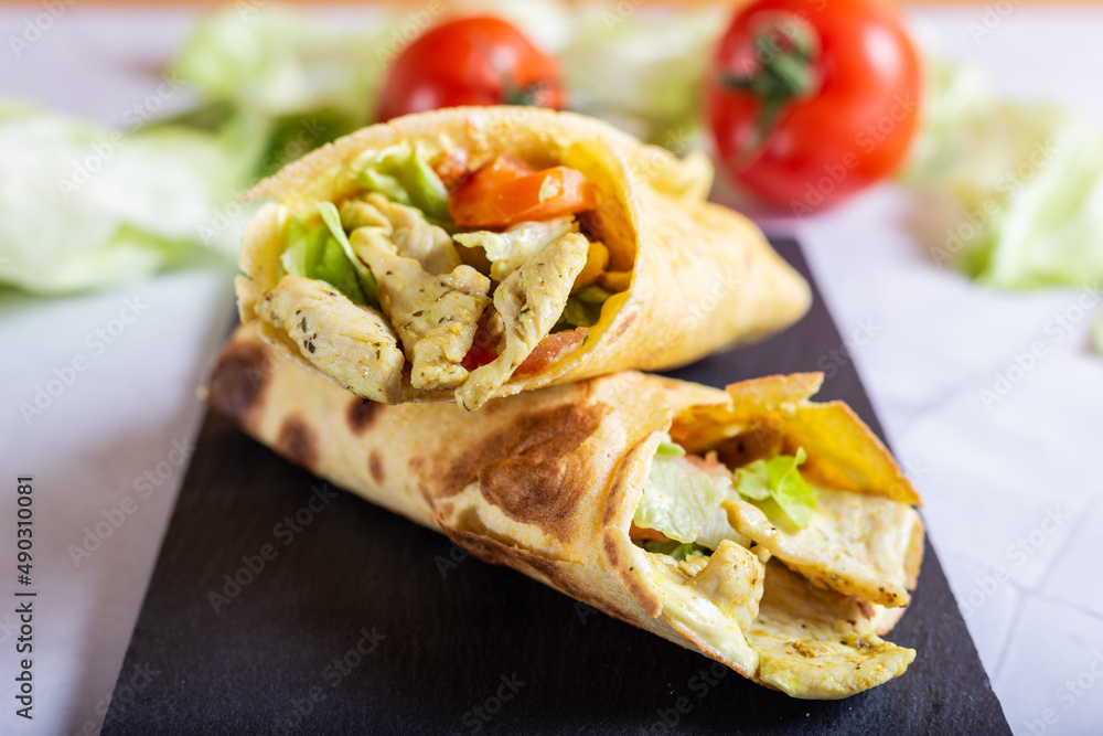 Chicken wrap with salad and tomato. Idea for a tasty and healthy lunch.