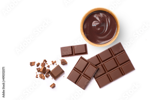 Dark chocolate cream in wooden bowl and broken pieces of chocolate bar isolated on white background. Top view. Flat lay.
