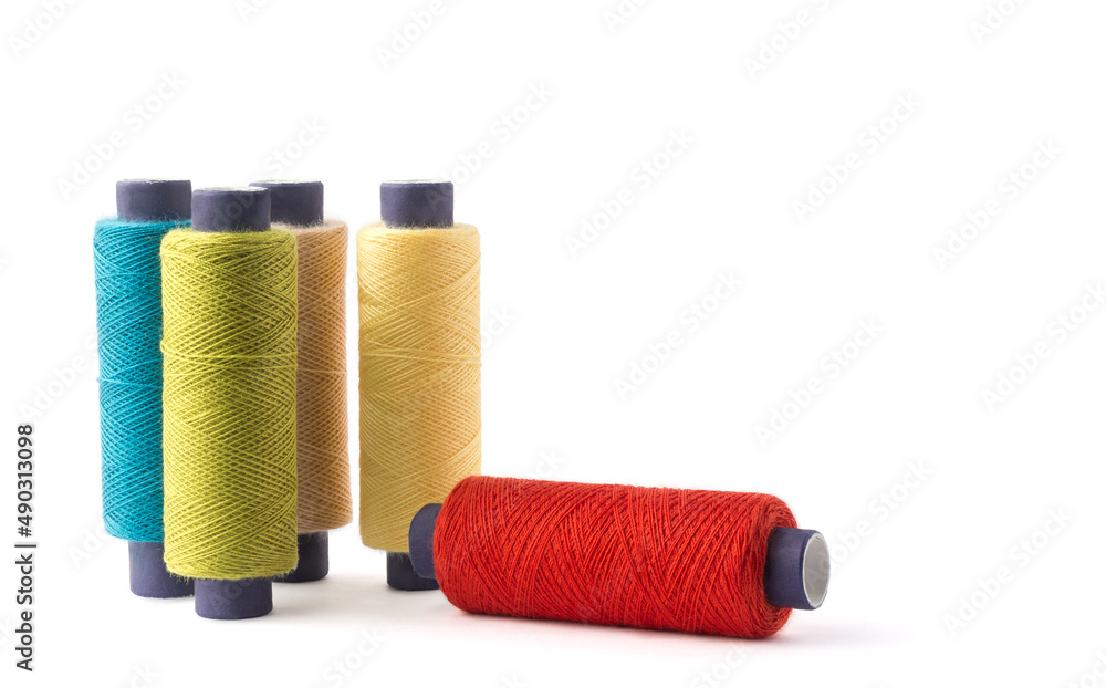 spool of sewing thread used in fabric and textile industry, different colors, isolated on white background spool of sewing thread used in fabric and textile industry, different colors, isolated on white background