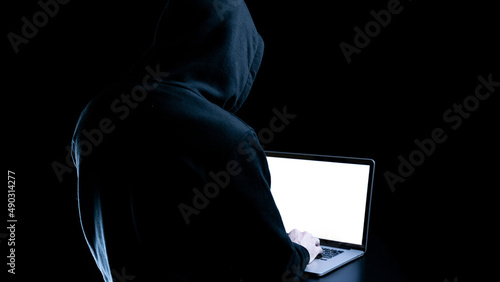 Cyber security hacker concept. Internet web hack technology. Digital laptop in hacker man hand isolated on black banner. Data protection, secured internet access, cybersecurity.