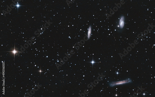 The Leo Triplet is a small group of galaxies about 35 million light-years away in the constellation Leo. This galaxy group consists of the spiral galaxies M65, M66, and NGC 3628 photo