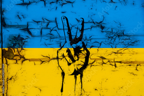 Victory sign with Ukrainian flag on rusted metal