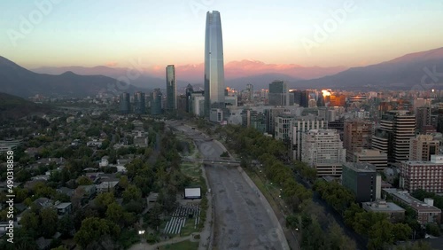 Aerial parallax of open air free cinema, Mapocho river, Sanhattan skyscraper and hills in background at blue hour in Providencia, Santiago, Chile photo