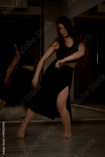 Beautiful modern ballet dancer on tiptoe posing in studio. Extreme flexibility.