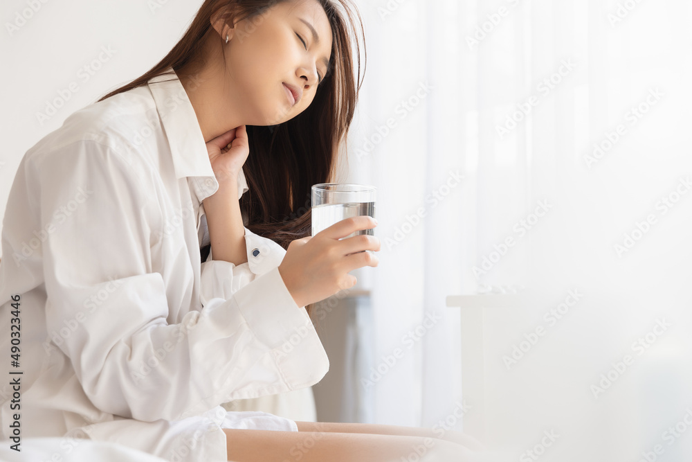 Asian woman feeling sick have a headache, coughing because of Coronavirus Covid-19. Protection and recovery from the illness quarantine at home, Stay at home. Asian woman feeling sick have a headache, coughing because of Coronavirus Covid-19. Protection and recovery from the illness quarantine at home, Stay at home.