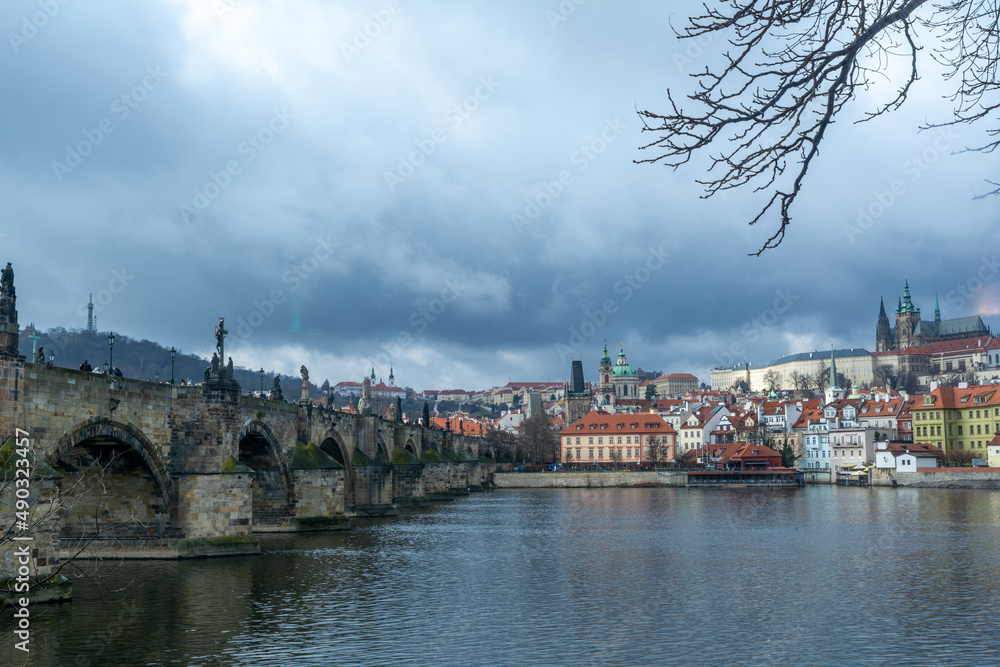 The famous Carles-Bridge in Prague on a cold winter day with a dramatic sky