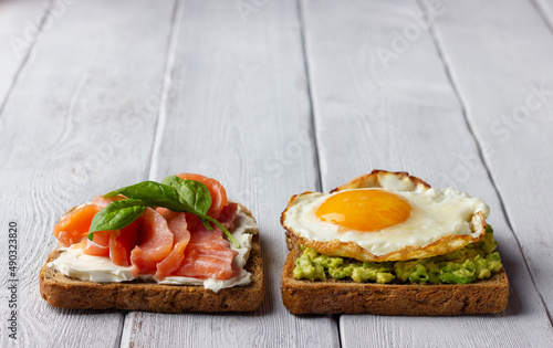 Background from sandwiches with smoked salmon, cream cheese, avocado and fried egg.