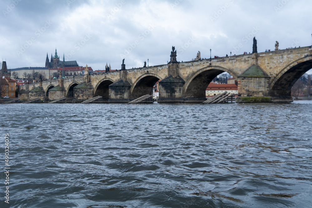 The famous Carles-Bridge in Prague on a cold winter day with a dramatic sky The famous Carles-Bridge in Prague on a cold winter day with a dramatic sky