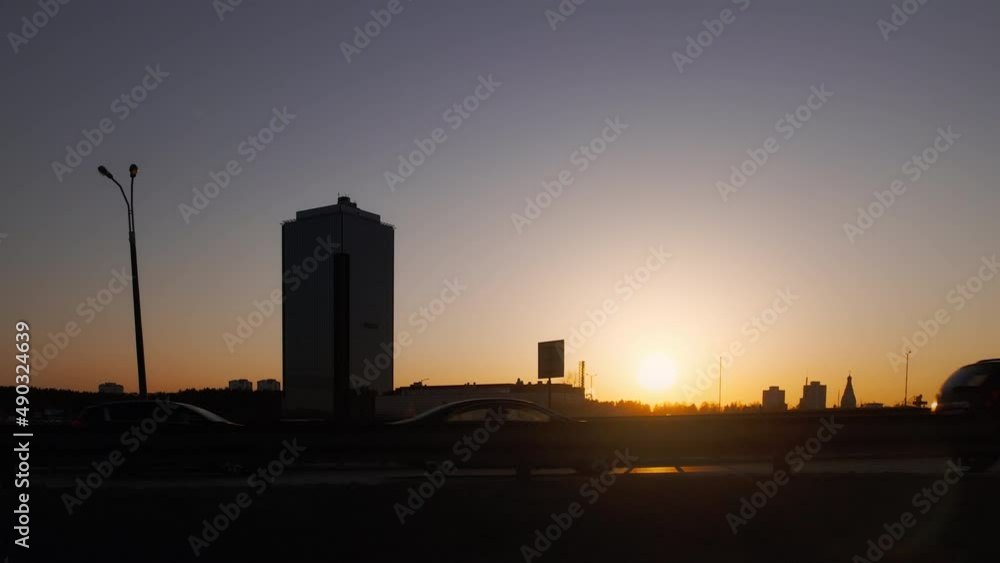 road with moving cars at sunset. automobile traffic in backlit sunlight road with moving cars at sunset. automobile traffic in backlit sunlight