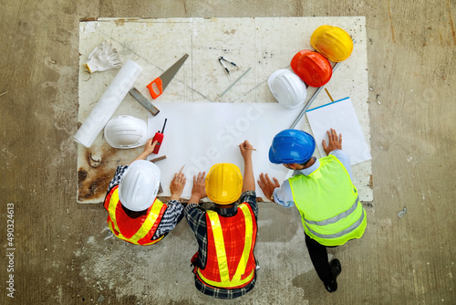 Concept Architects & Teamwork Engineers : Planning meetings, architects and engineers : Top view Fieldwork Three team of architects and engineers working in the construction area.