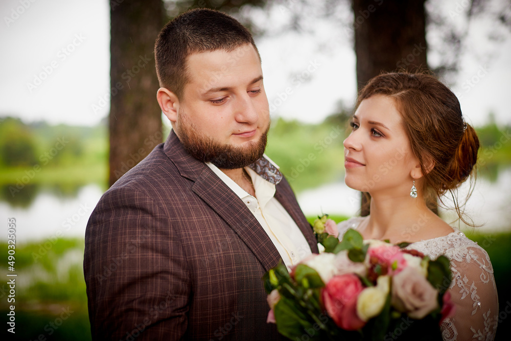 Wedding concept. Bride and groom in green park in a summer day Wedding concept. Bride and groom in green park in a summer day