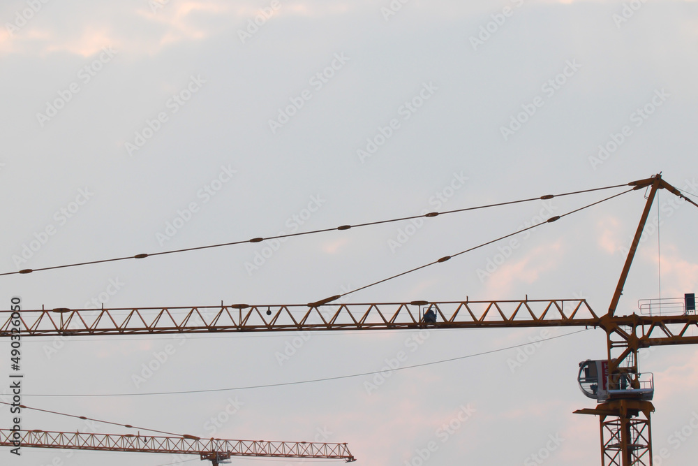 Tower crane working on building construction, beautiful sky