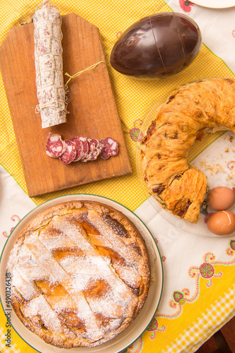 Easter breakfast in Italy whit Colomba cake chocholat egg corallina salami Casatiello cake from Naples and Pastiera cake from campania Region photo