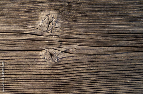 Old wooden plank with two knots close
