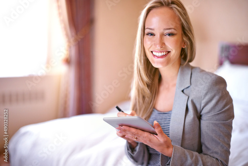 Cant wait to get this day started. A young businesswoman using a digital tablet in a bedroom. © Yuri Arcurs/peopleimages.com
