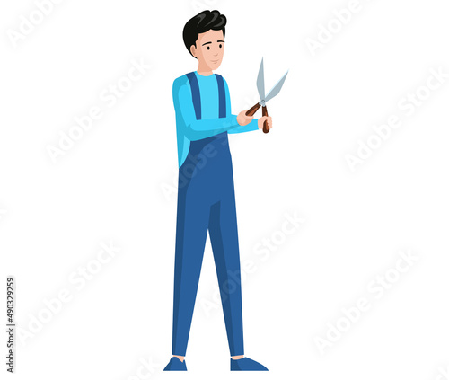 Young man standing with garden shears isolated on white background. Gardener or worker in jumpsuit with foliage scissors. Guy cares for garden. Male character holding scissors to cut bushes
